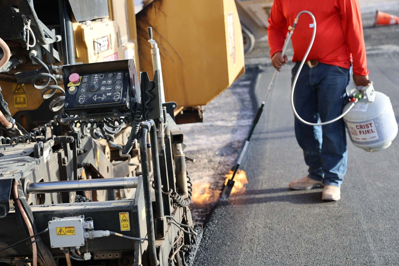 Asphalt paving equipment working on a road construction project
